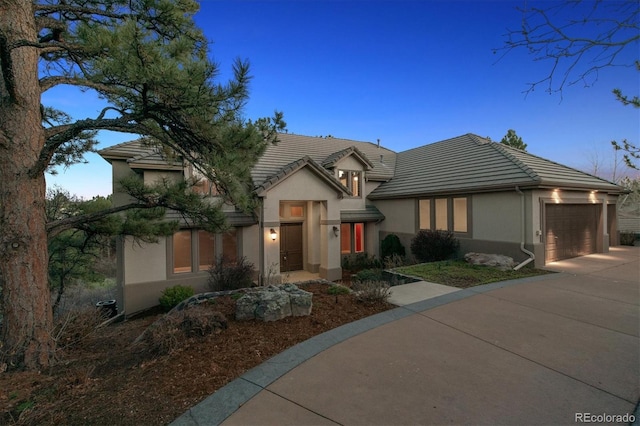 902 Anaconda Ct, Castle Rock, CO 80108 - traditional home featuring stucco siding, a tiled roof, and driveway