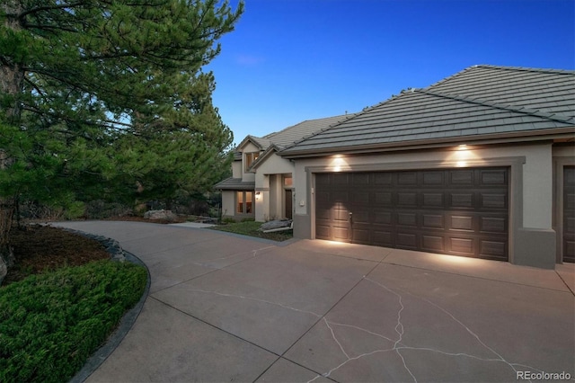 902 Anaconda Ct, Castle Rock, CO 80108 - view of front of house with driveway, stucco siding, a tile roof, and a garage