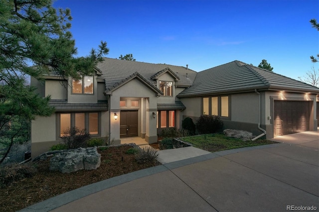 902 Anaconda Ct, Castle Rock, CO 80108 - traditional-style home with a tile roof, concrete driveway, a garage, and stucco siding
