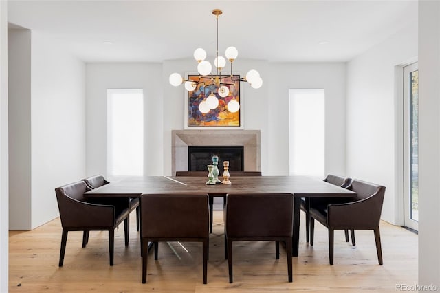 dining area with a chandelier and light hardwood / wood-style floors