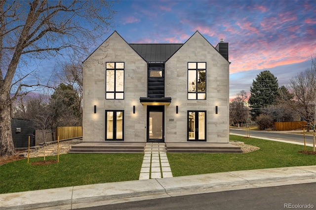 modern home featuring a yard and french doors