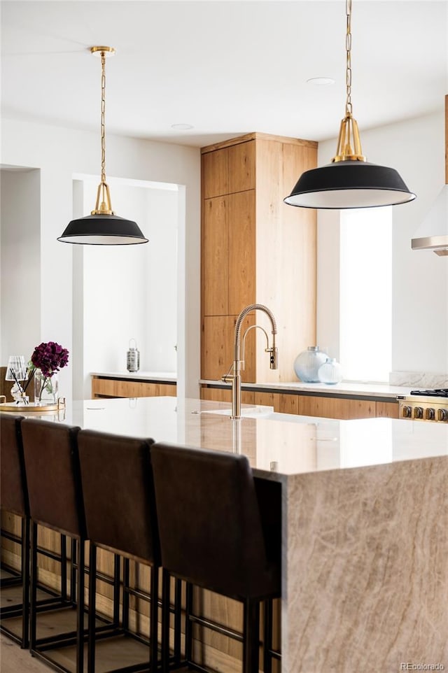 kitchen featuring a kitchen breakfast bar and decorative light fixtures