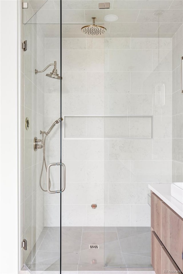 bathroom with vanity and a shower with shower door