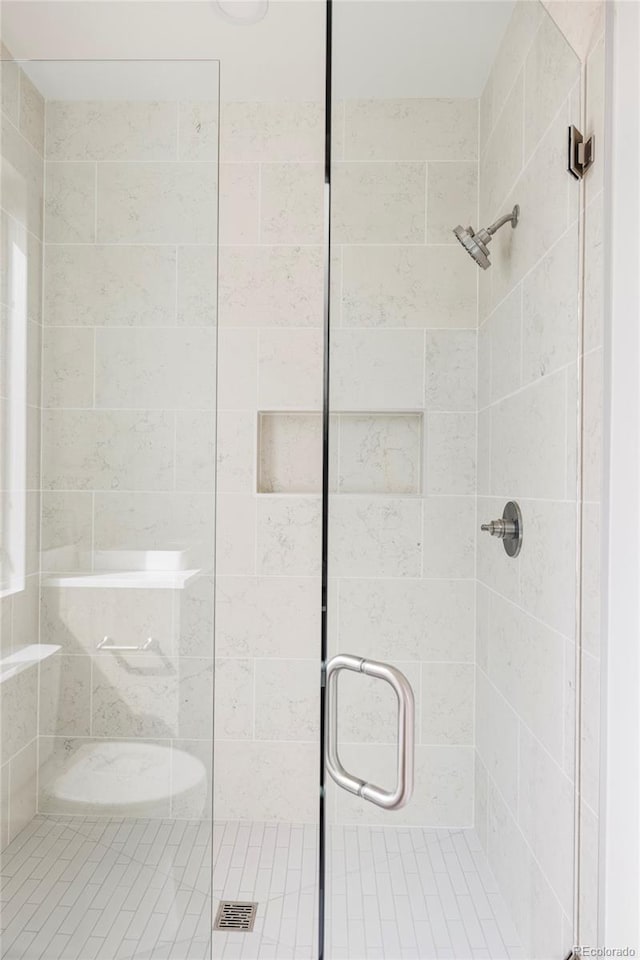 bathroom with a shower with shower door