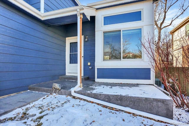 view of snow covered property entrance