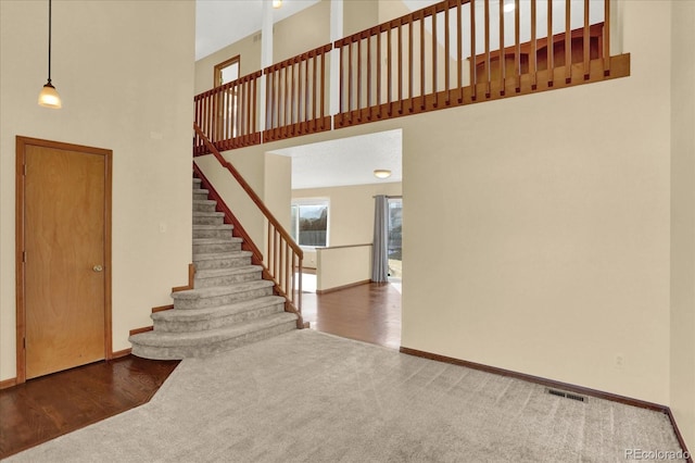 interior space with a high ceiling and carpet