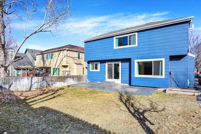 rear view of property featuring a yard and a patio area