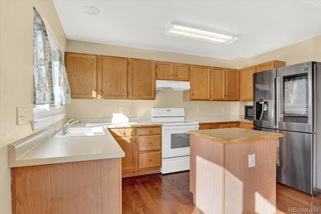 kitchen with stainless steel appliances, dark hardwood / wood-style flooring, sink, and a kitchen island