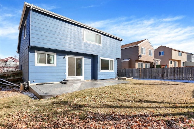 back of property with a patio and a yard