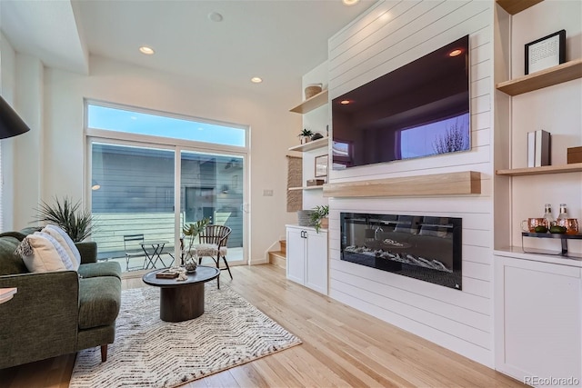 living room with a fireplace and light hardwood / wood-style flooring