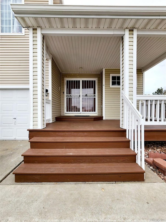 view of exterior entry featuring covered porch