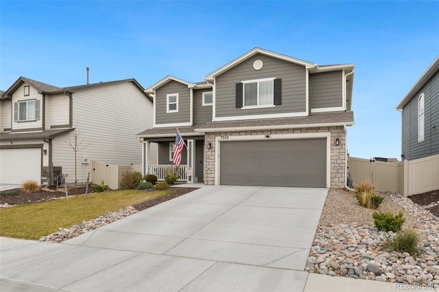 traditional-style home with a porch, stone siding, an attached garage, and concrete driveway