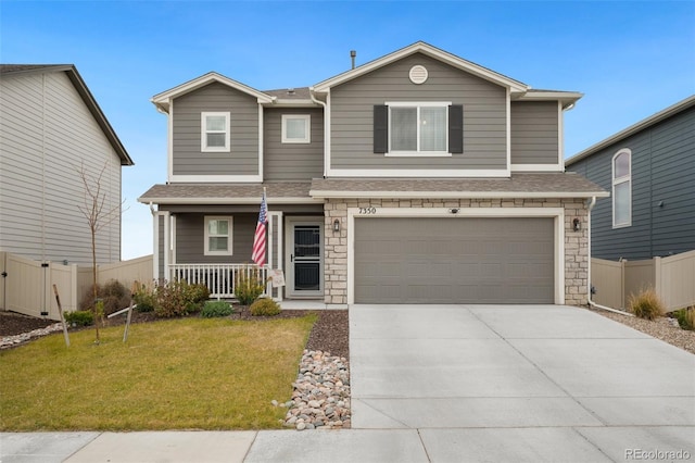 traditional-style house with a garage, driveway, a front yard, and fence