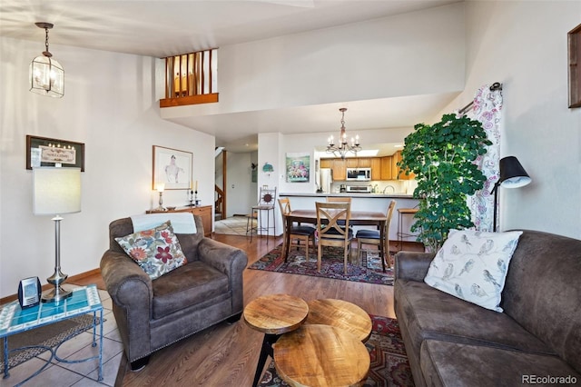 living room with wood-type flooring and a notable chandelier