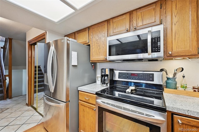 kitchen featuring stainless steel appliances and light tile patterned floors