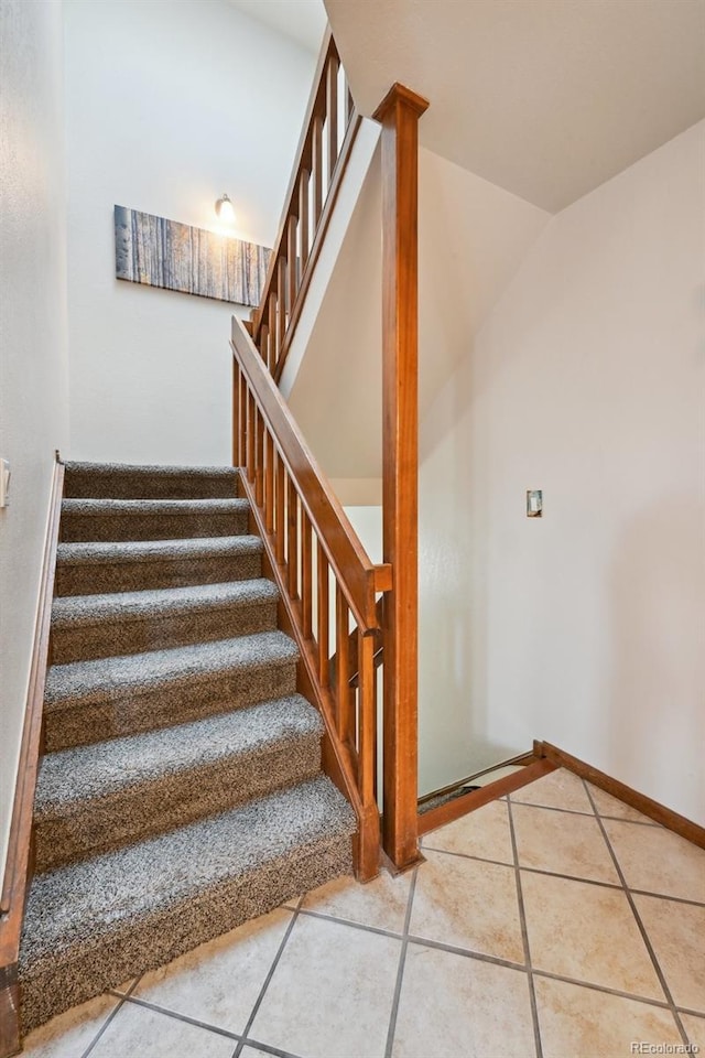 stairs with tile patterned flooring