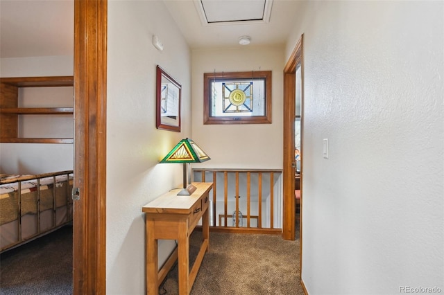 hallway with dark colored carpet