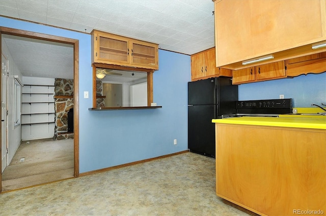 kitchen featuring black appliances, light colored carpet, and sink