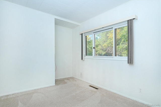 empty room featuring light colored carpet