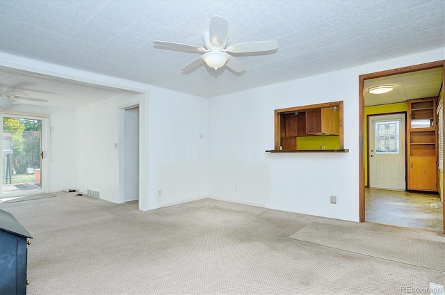 unfurnished living room with ceiling fan and light colored carpet