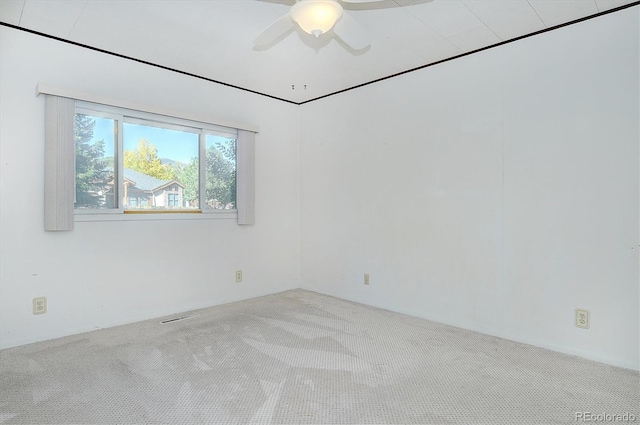 unfurnished room with ceiling fan and light colored carpet