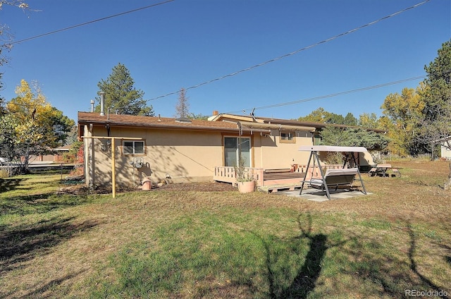 rear view of house with a lawn, a patio, and a deck