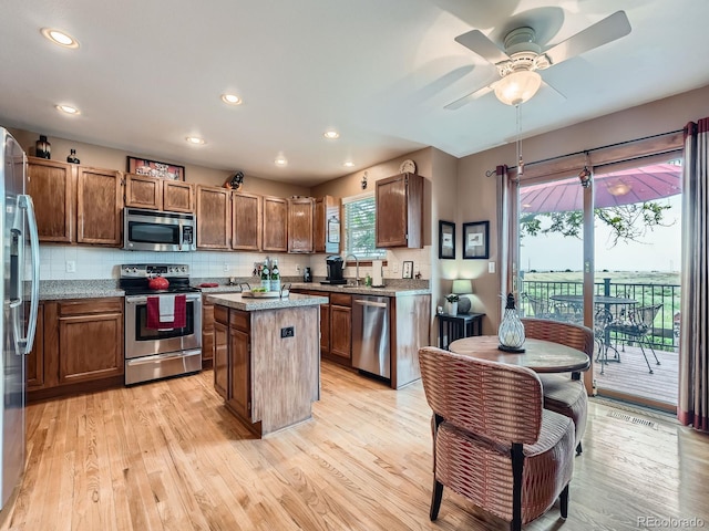 3691 Bucknell Dr, Highlands Ranch, CO 80129 - kitchen featuring stainless steel appliances, a center island, a ceiling fan, light wood-type flooring, and recessed lighting