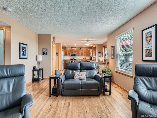 3691 Bucknell Dr, Highlands Ranch, CO 80129 - living area with light wood-style floors, a textured ceiling, and ceiling fan