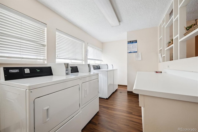 laundry room with independent washer and dryer, dark hardwood / wood-style floors, and a textured ceiling