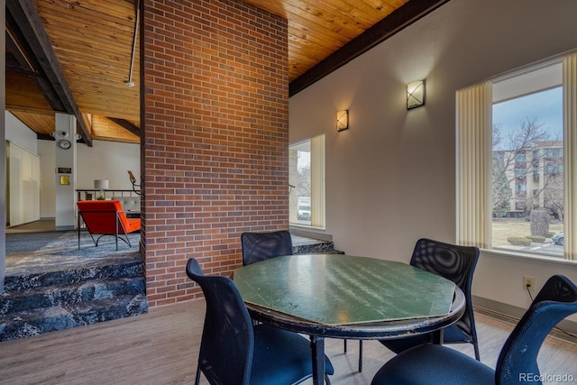 dining area featuring vaulted ceiling, wooden ceiling, and light hardwood / wood-style flooring