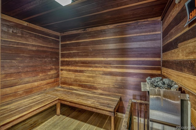 view of sauna featuring hardwood / wood-style flooring and wooden walls