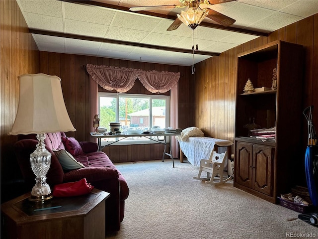 10425 Franklin Way, Northglenn, CO 80233 - carpeted living area featuring wood walls, a ceiling fan, and a drop ceiling
