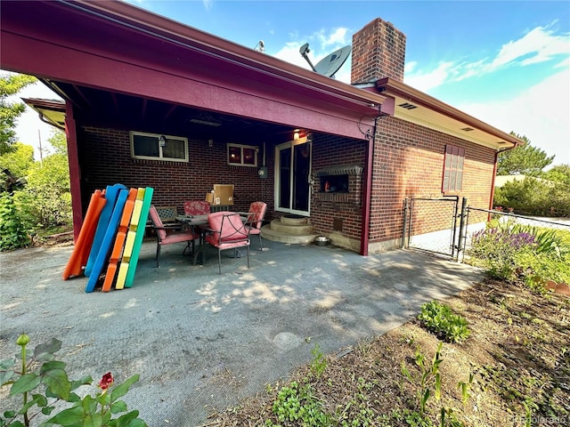 10425 Franklin Way, Northglenn, CO 80233 - back of house featuring brick siding, a patio area, and a chimney