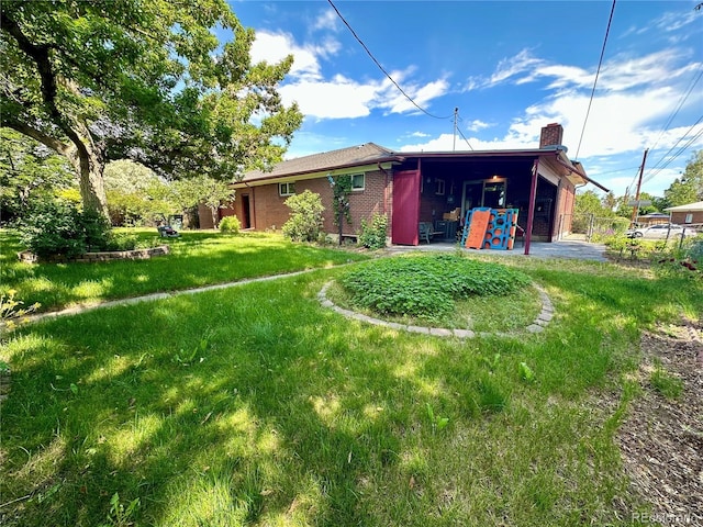 10425 Franklin Way, Northglenn, CO 80233 - rear view of property featuring a chimney, a patio, and brick siding