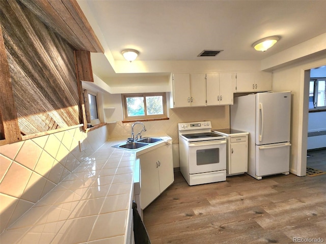 18 Columbia Dr, Julesburg, CO 80737 - kitchen with white appliances, tile counters, radiator, a sink, and white cabinets