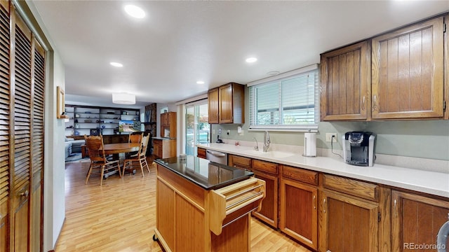 7865 S Lafayette Ct, Centennial, CO 80122 - kitchen featuring dishwasher, light wood-style floors, a kitchen island, brown cabinetry, and recessed lighting