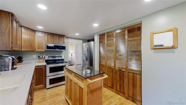 7865 S Lafayette Ct, Centennial, CO 80122 - kitchen with appliances with stainless steel finishes, light wood finished floors, recessed lighting, and a center island