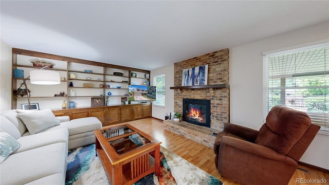 7865 S Lafayette Ct, Centennial, CO 80122 - living room featuring a brick fireplace and light wood-type flooring