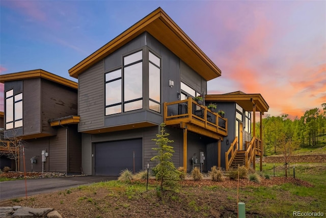 14 E Baron Way, Silverthorne, CO 80498 - back of property at dusk with an attached garage, stairway, and driveway