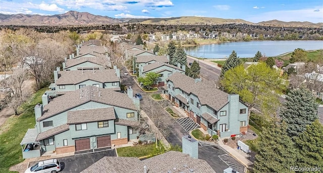 aerial view featuring a water and mountain view