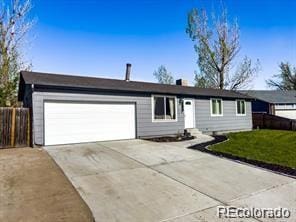 ranch-style house featuring a garage and a front yard