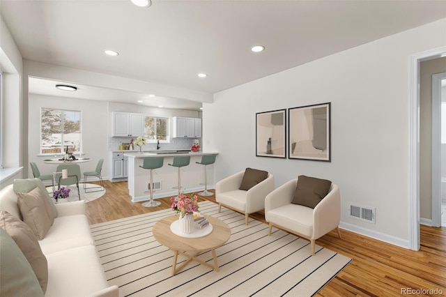 7555 E 22nd Ave, Denver, CO 80207 - living room featuring recessed lighting, light wood-type flooring, and baseboards