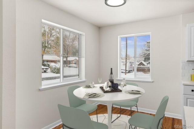 7555 E 22nd Ave, Denver, CO 80207 - dining space with plenty of natural light, baseboards, and wood finished floors