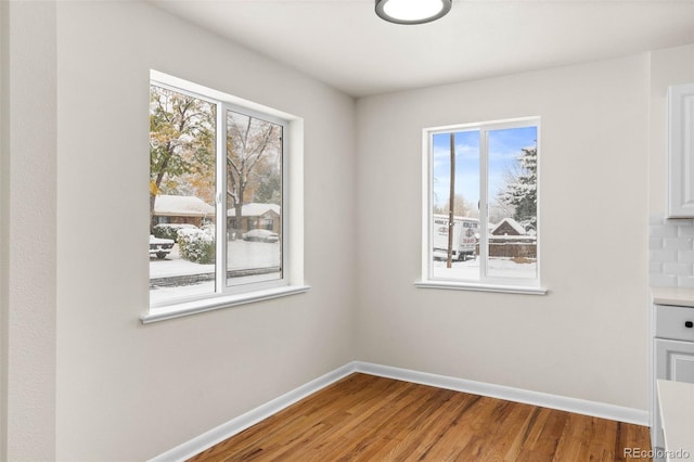 7555 E 22nd Ave, Denver, CO 80207 - spare room featuring baseboards and wood finished floors