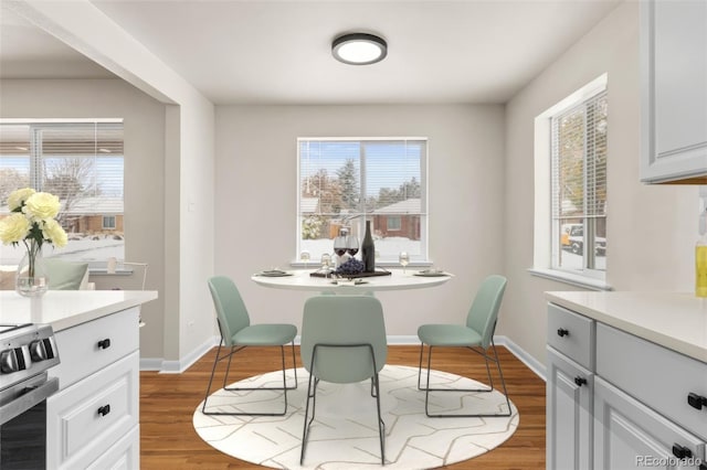 7555 E 22nd Ave, Denver, CO 80207 - dining area featuring plenty of natural light, baseboards, and wood finished floors