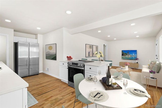 7555 E 22nd Ave, Denver, CO 80207 - kitchen featuring appliances with stainless steel finishes, a peninsula, light wood-type flooring, light countertops, and recessed lighting