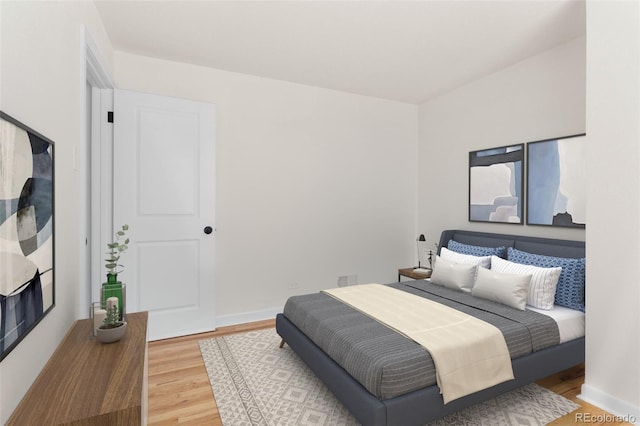 7555 E 22nd Ave, Denver, CO 80207 - bedroom featuring light wood-type flooring and baseboards