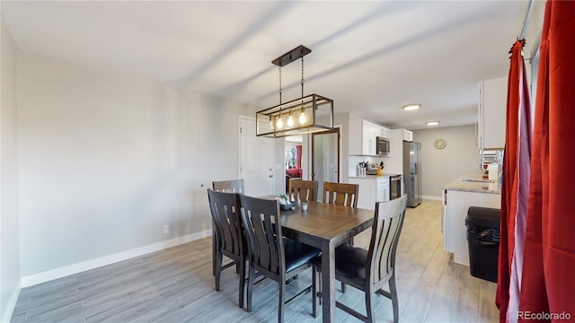 dining space featuring light wood-type flooring