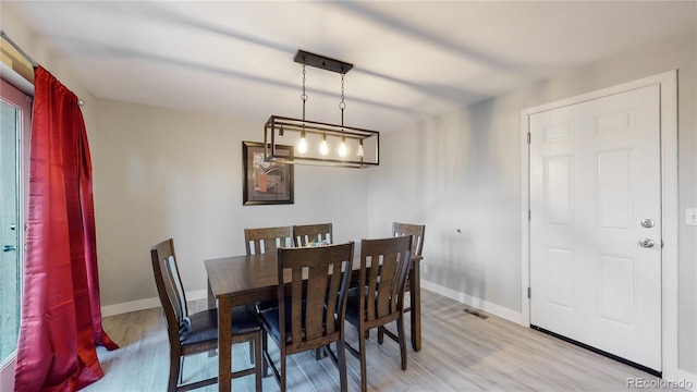 dining space featuring light wood-type flooring