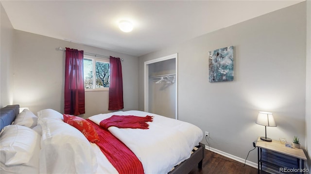 bedroom featuring dark hardwood / wood-style floors and a closet